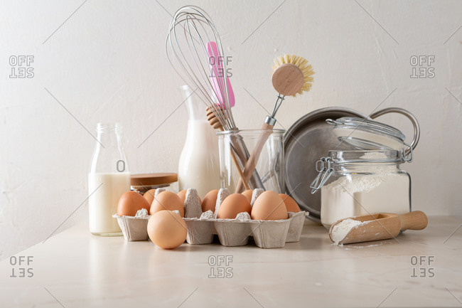 Ingredients and utensils on kitchen counter for preparing custard cream