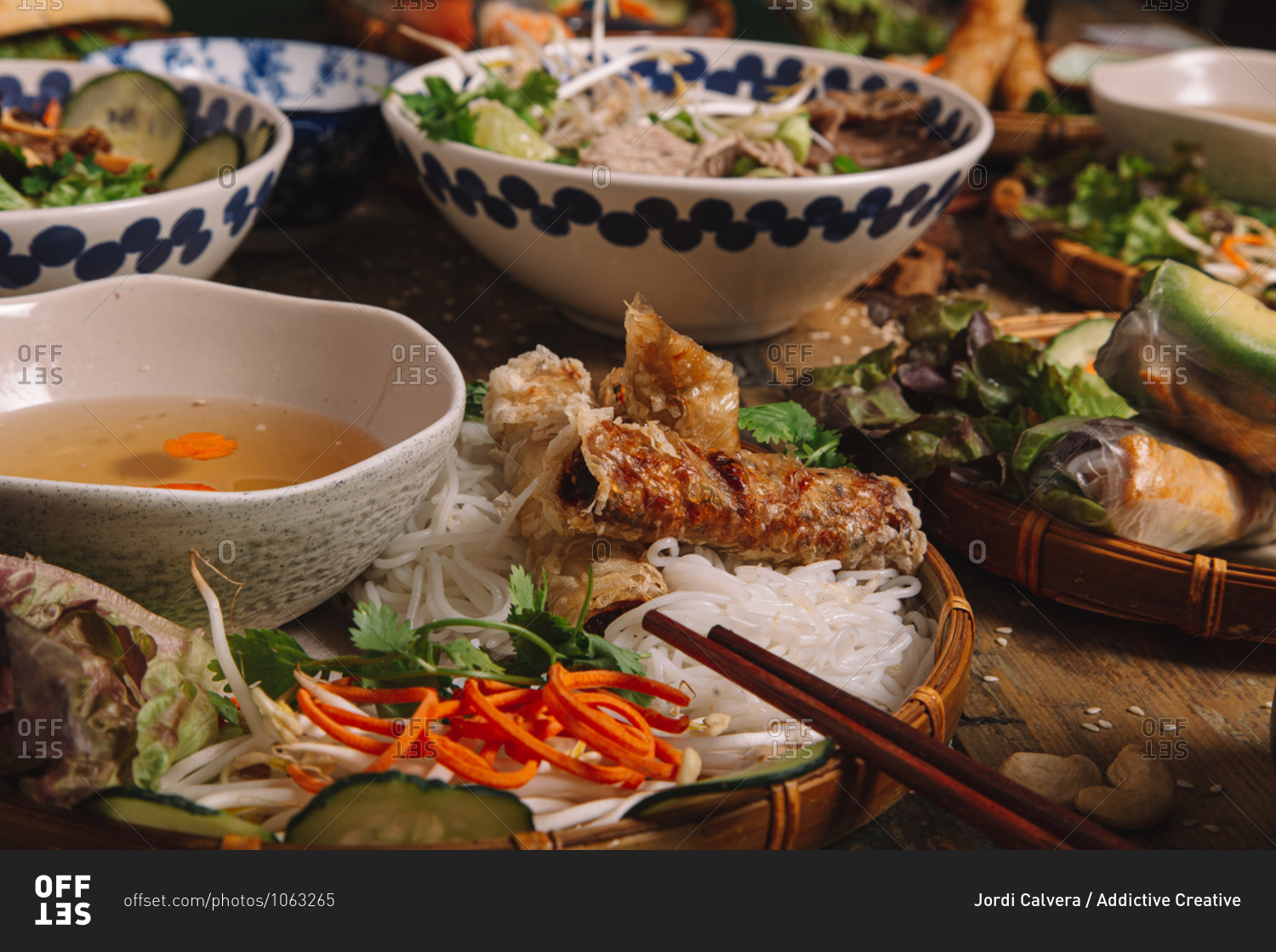 From above of assorted dishes of Vietnamese cuisine arranged on wooden table in luxury restaurant