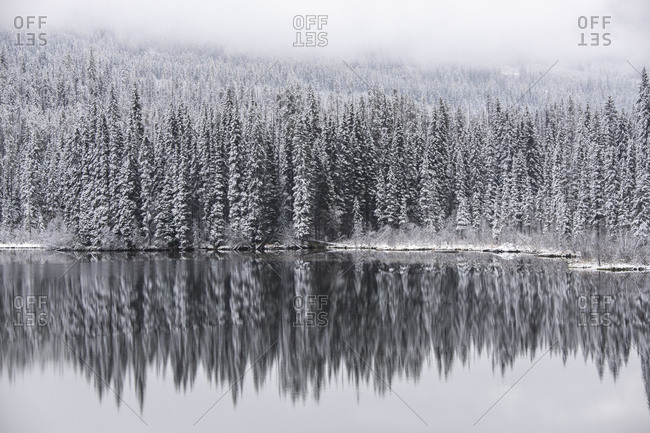 The first touch of winter on an alpine lake in the interior of British Columbia