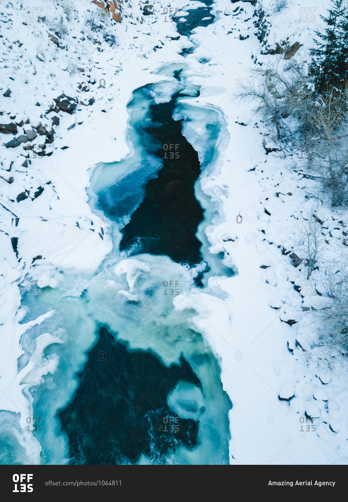Aerial view of frozen lake in snow forest close to Denver, Colorado, USA.