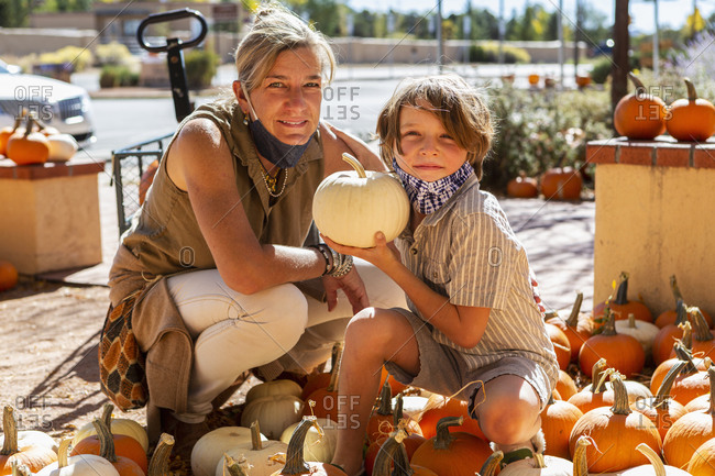 Mother and her young son in pumpkin patch.