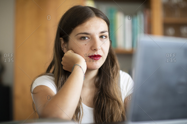 Young woman working at computer in library