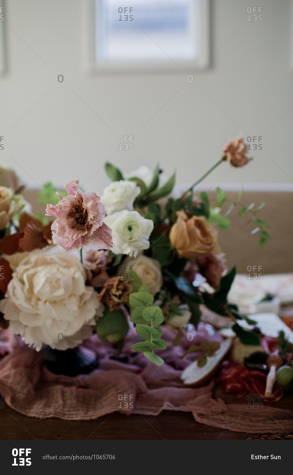 Floral arrangement on a party table with food