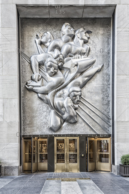 July 13, 2018: USA, New York, Midtown Manhattan, Rockefeller Center, the entrance at 50 Rockefeller Plaza with the Art Deco bas-relief "News" by Isamu Noguchi