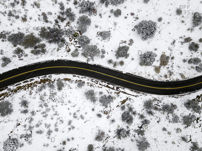 Drone View of a Winding Road in the Snow at the Sandia Mountains in New Mexico