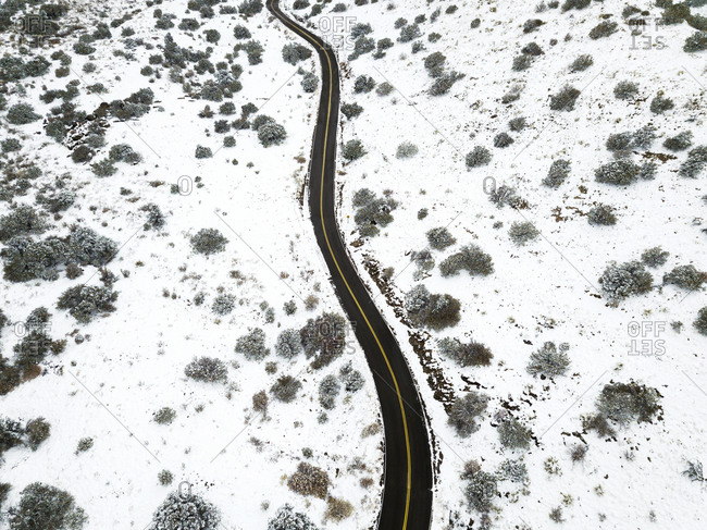 Drone View of a Winding Road in the Snow at the Sandia Mountains in New Mexico