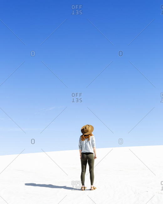Redhead Woman Hiking on Sand Dunes at White Sands Park in New Mexico