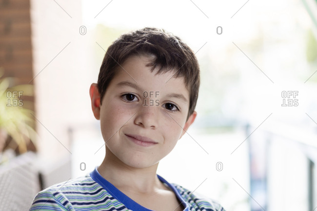 Close up of a child looking at camera with joyful smile