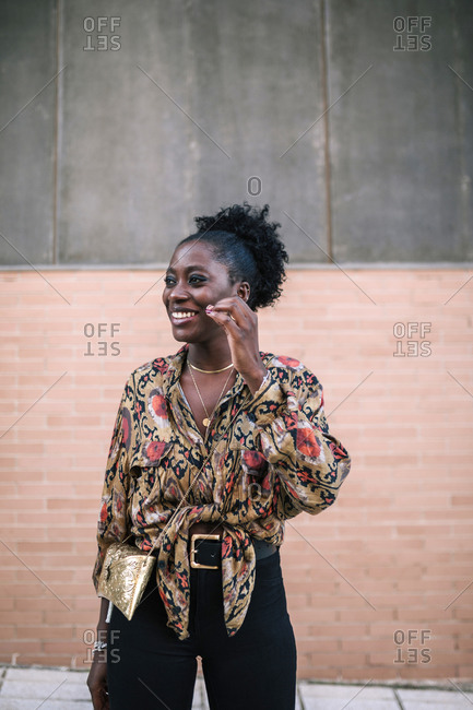 Portrait of young black woman smiling in the city
