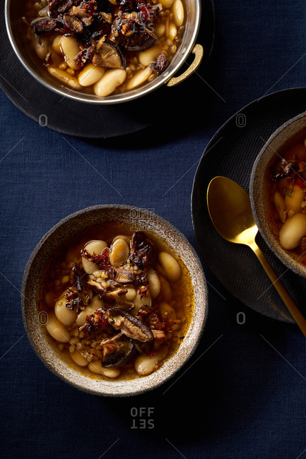 Hot stew with lima beans, shiitake mushrooms, farro and egg yolk.