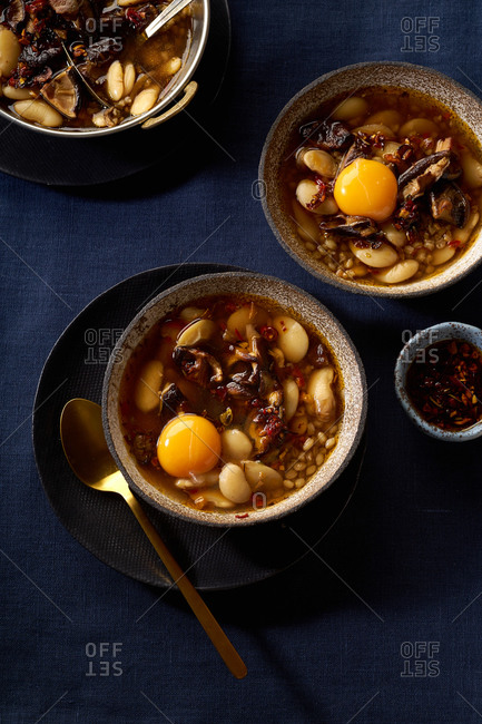Hot stew with lima beans, shiitake mushrooms, farro and egg yolk.