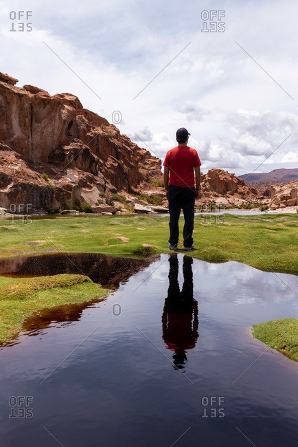 Reflection of a man in a scenic lake in the southwest of the Bolivian altiplano