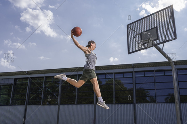 people playing basketball outside dunking