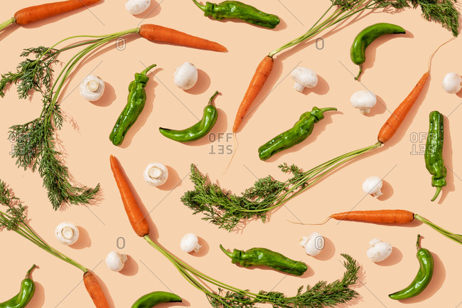Studio shot of fresh green chili peppers- carrots and mushrooms