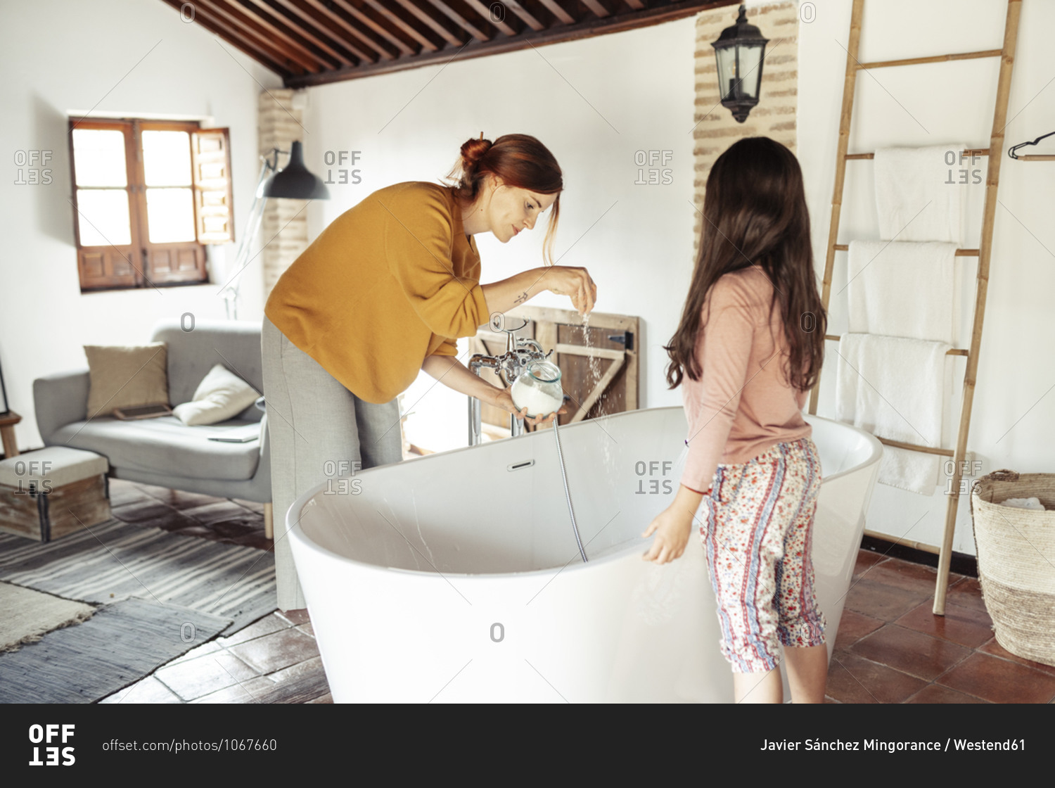 Woman taking a bath in bath tub at home stock photo - OFFSET