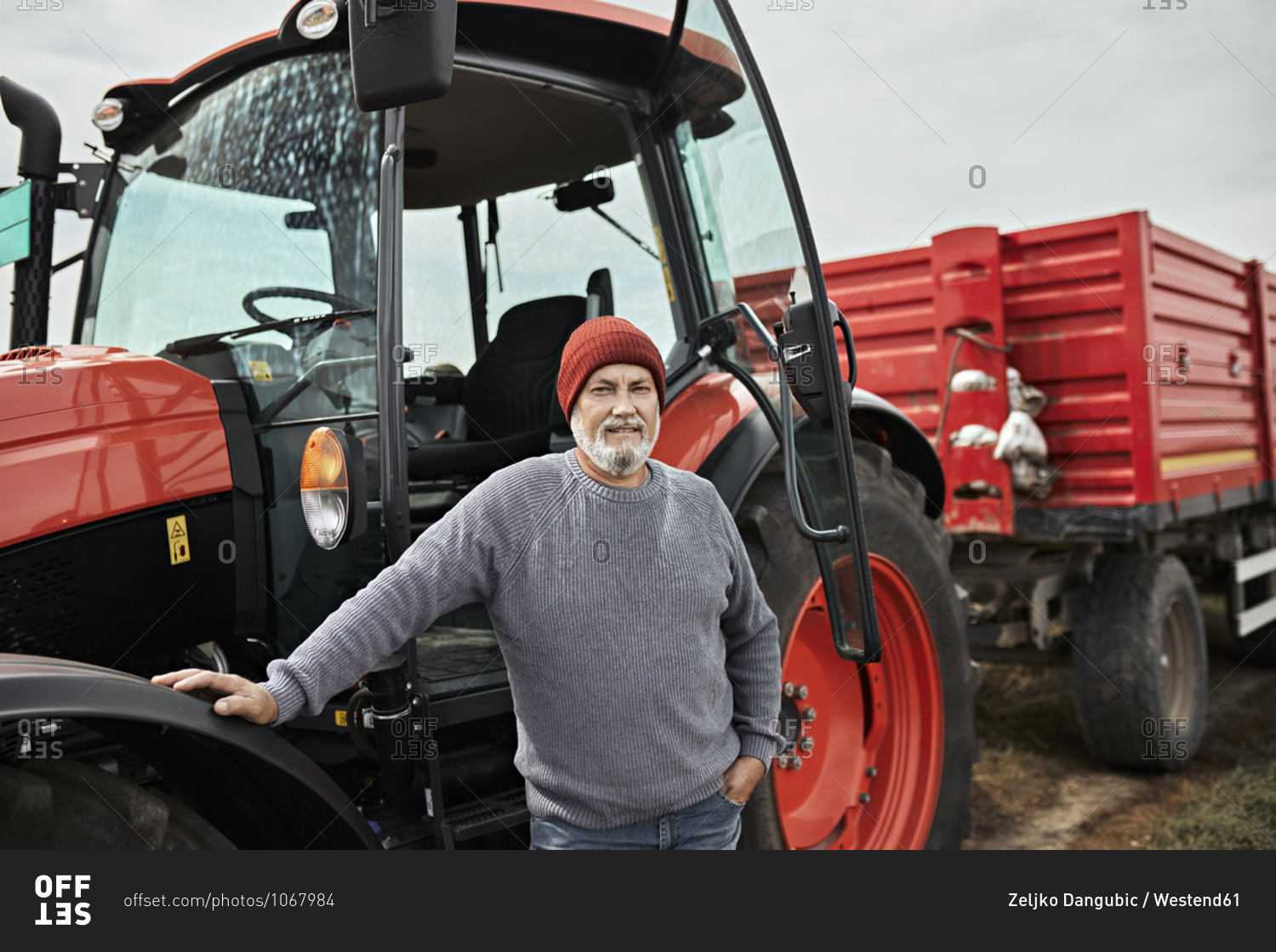 Farmer standing by tractor at soybean farm