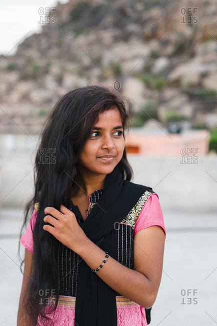 Hampi, Karnataka, India - April 07, 2019: Proud Indian woman touching hair wearing traditional clothes