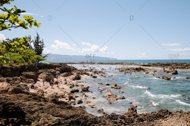 Tourists explore Shark's Cove on the North Shore of Honolulu, Oahu, Hawaii
