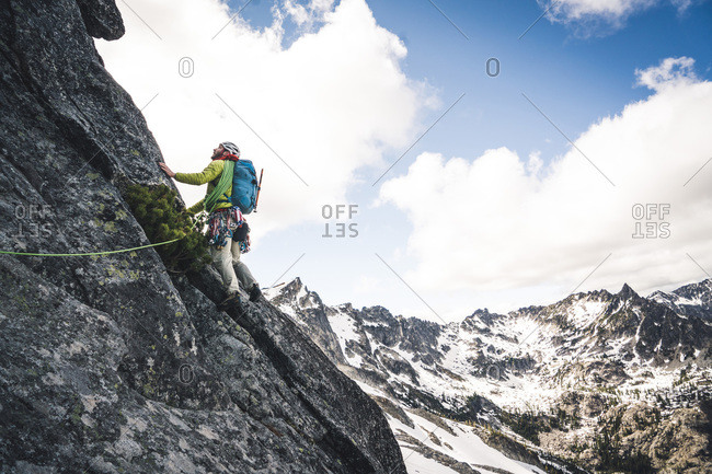 Man lead climbing on alpine rock route in Washington