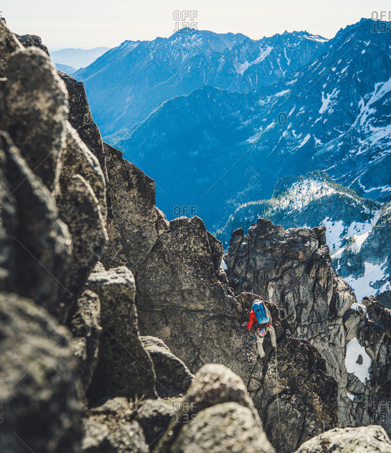 Man climbing rock face in Washington mountains