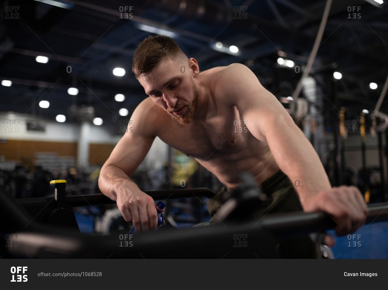 Exhausted sportsman resting on treadmill