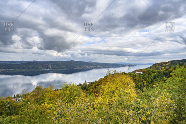 Clouds over Lake Constance ale lakeshore forest in autumn