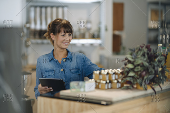 Female owner checking quality of product in cafe