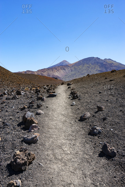 Empty trail stretching across volcanic landscape of Tenerife