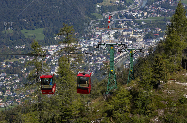 Austria- Upper Austria- Bad Ischl- Overhead cable cars with alpine town in background