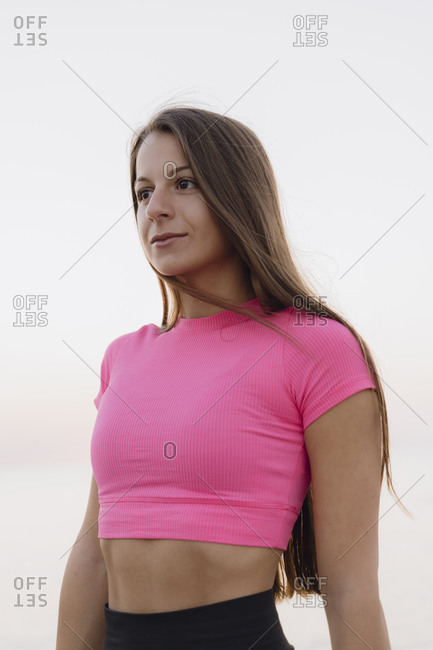 Young beautiful woman standing against clear sky