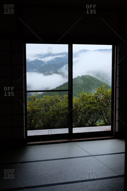 View from window overlooking cloud covered mountains in Wakayama, Japan