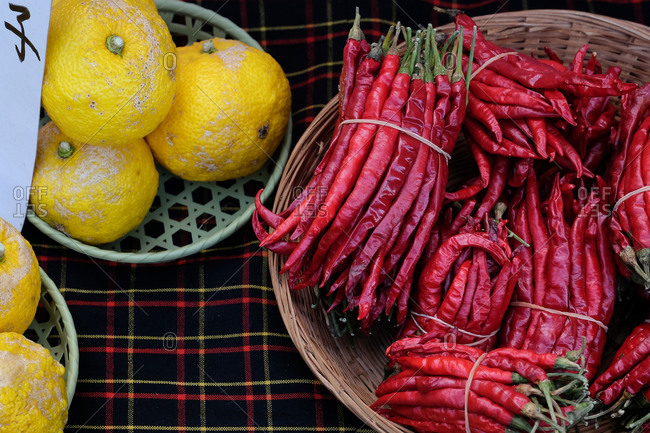 Lemons and red chili peppers in baskets