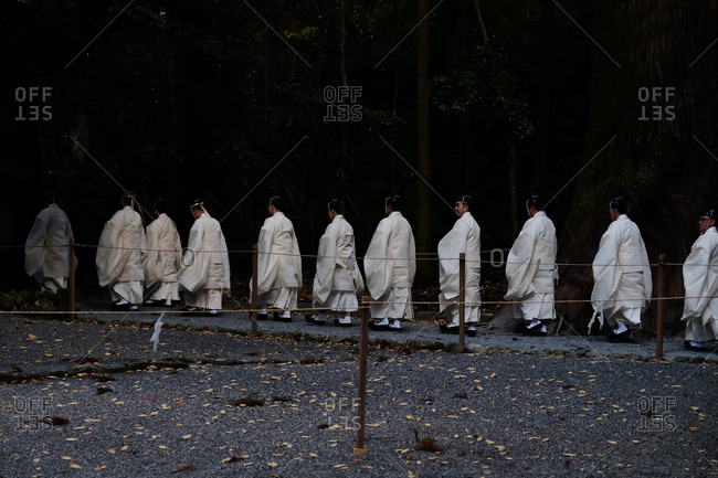 Wakayama, Japan - November 23, 2017: Group of monks in white robes walking in a line