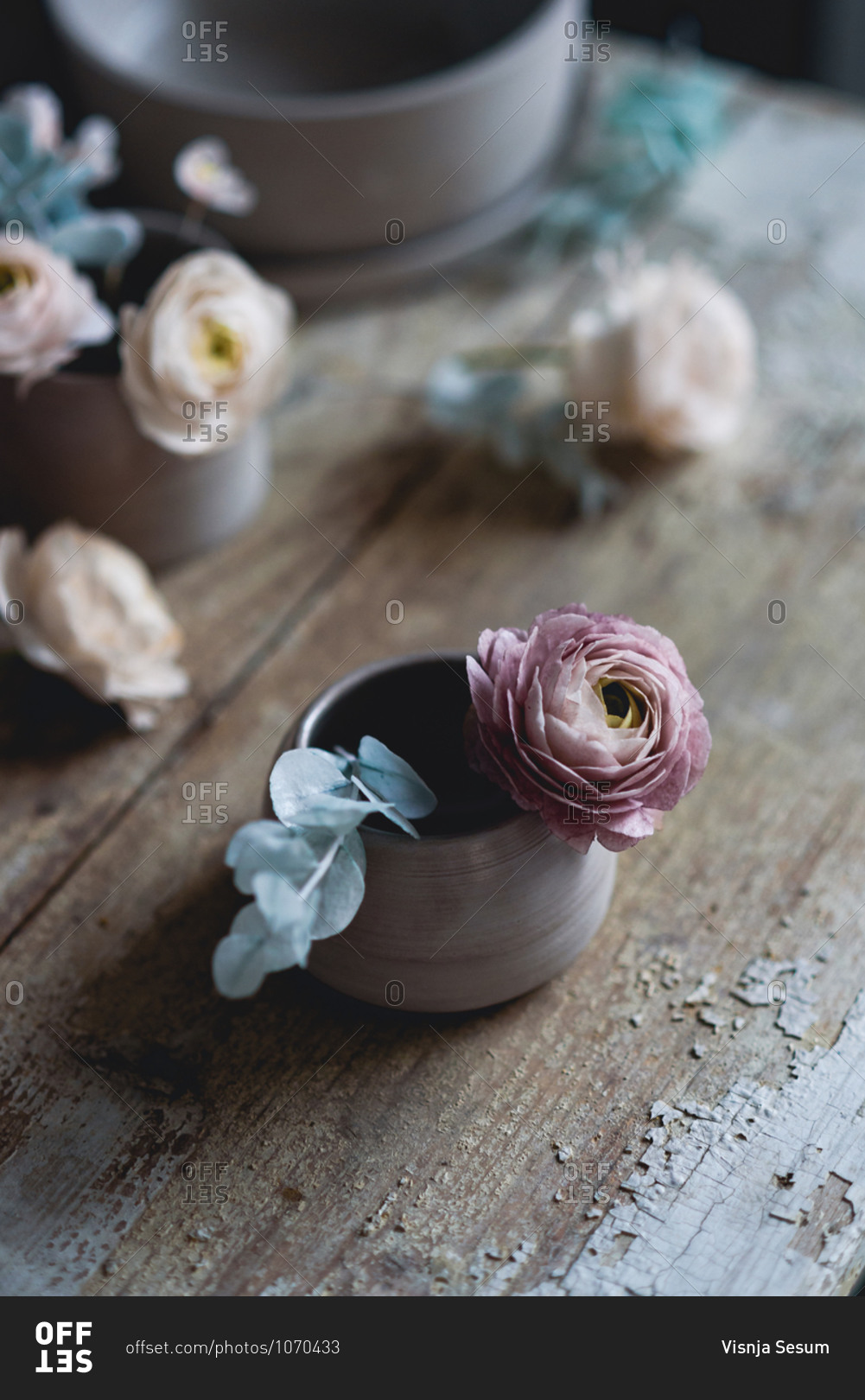 Overhead view of handmade ceramic cup with flowers inside