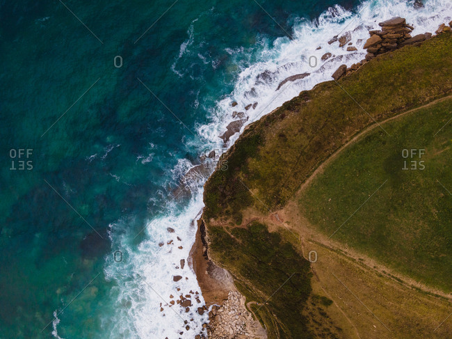 Aerial view of majestic rough coastline and calm sea with turquoise water