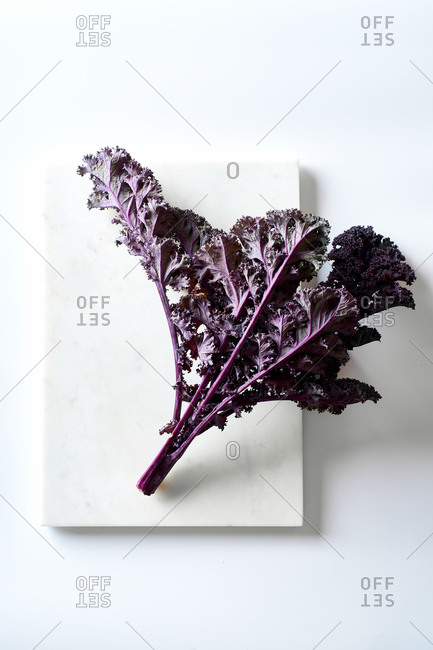 Red kale on white background top view
