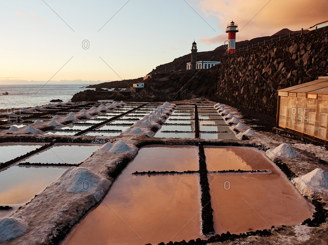 Amazing scenery of salt flats located near sea at sunset in La Palma in Spain