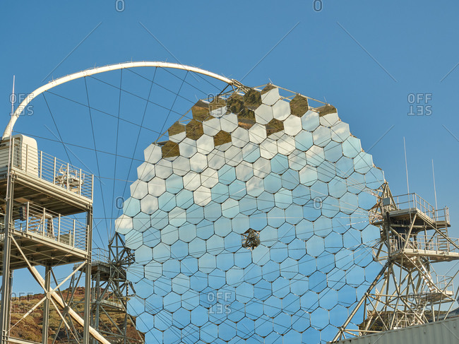 MAGIC telescope with mirror segments against cloudless blue sky in daylight at astronomical observatory site on island of La Palma in Spain