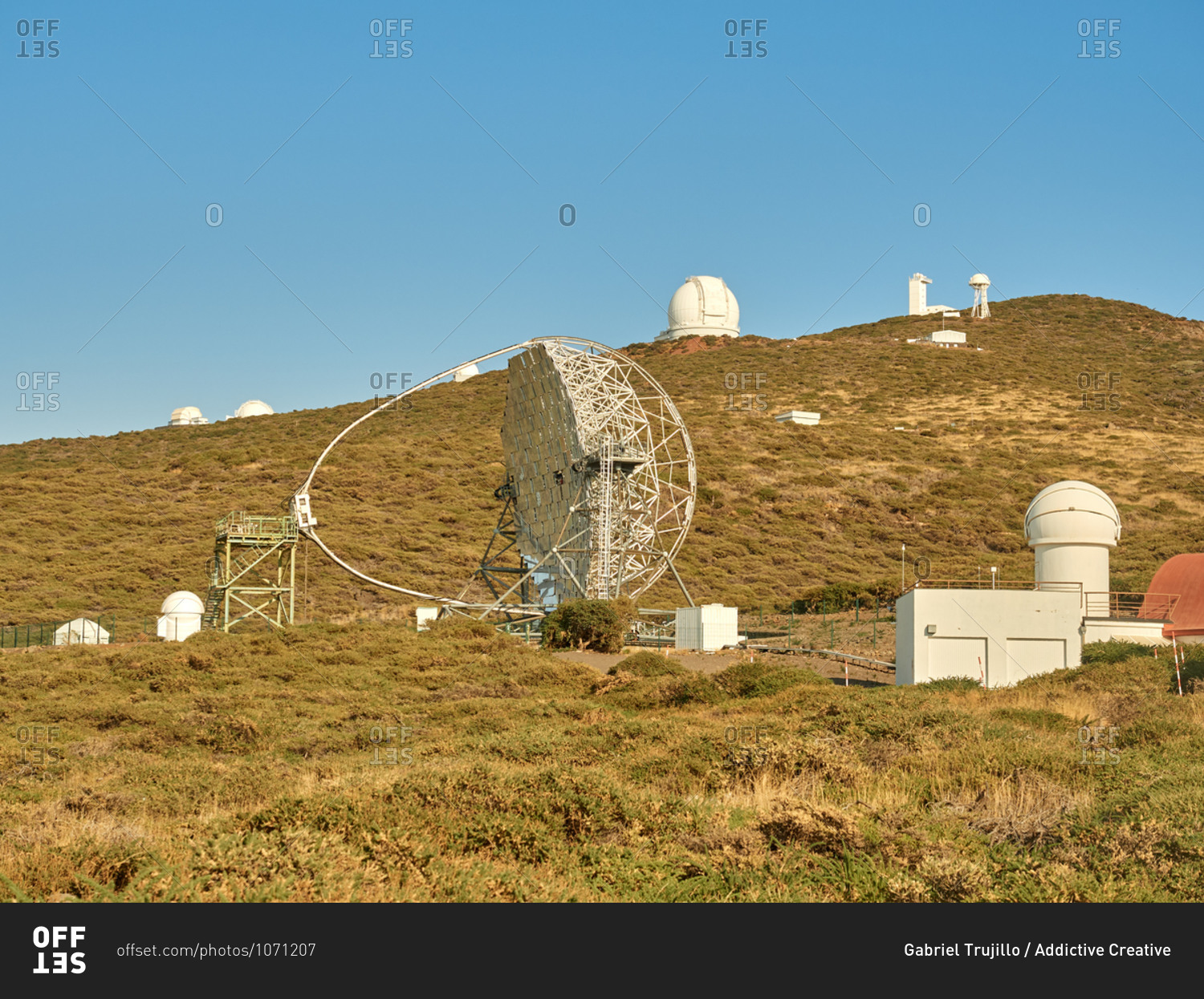 Various modern telescopes including MAGIC or Major Atmospheric Gamma Imaging Cherenkov Telescope located on hill slope at astronomical observatory on island of La Palma in Spain