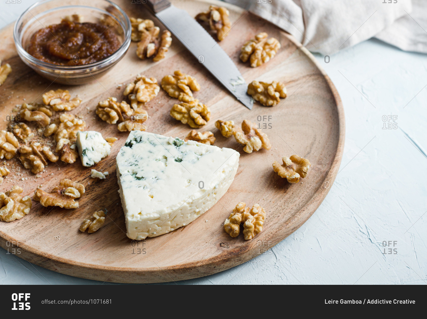Top view of appetizing blue cheese and walnuts prepared on wooden board in kitchen for cooking tasty homemade cheesecake
