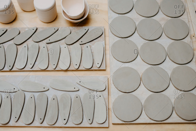From above of pieces of clay of different sizes and shapes prepared on workbench for creating pottery in studio