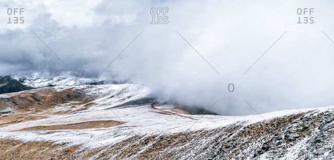 Severe cold landscape of foggy snowy Pyrenees mountains with Envalira pass in winter day
