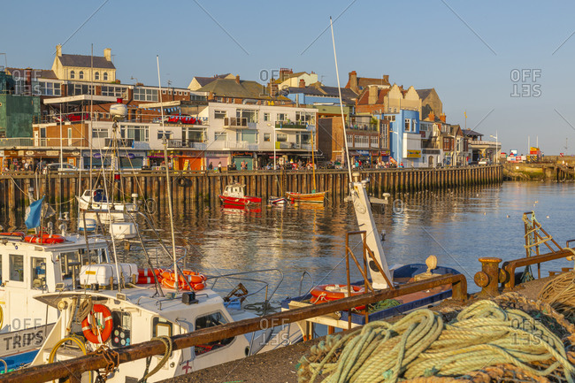 September 14, 2020: View of harbor boats and harborside shops in Bridlington Harbor at sunset, Bridlington, East Yorkshire, England, United Kingdom, Europe