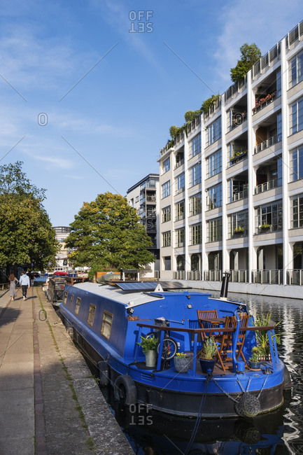Summer view of the Regent's shipping canal in Camden with locals walking on the towpath, Camden, London, England, United Kingdom, Europe