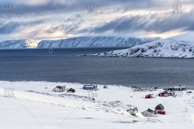 Fishing village of Honningsvag covered with snow surrounded by the icy sea, Nordkapp, Troms og Finnmark, Northern Norway, Scandinavia, Europe