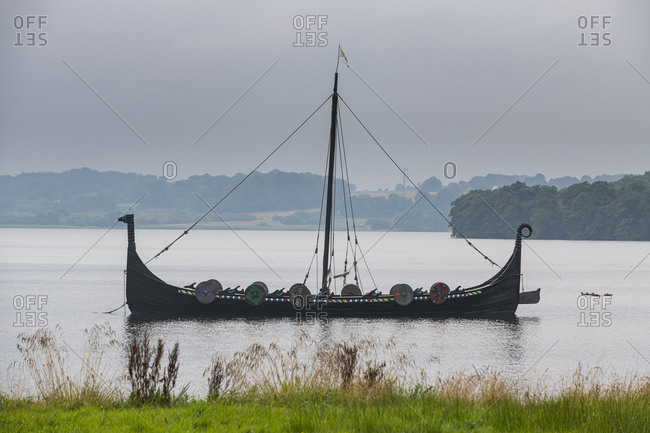 August 20, 2020: Viking boat on a lake,  Jelling Stones, UNESCO World Heritage Site, Jelling, Denmark, Scandinavia, Europe