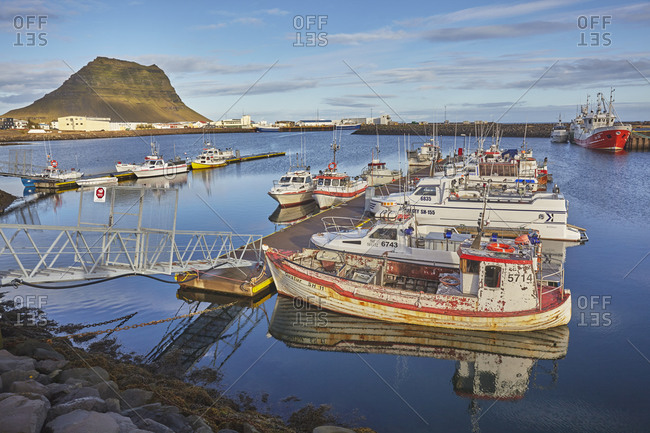 September 23, 2015: A fishing boat in the harbor at Grundarfjordur, with Mount Kirkjufell as a backdrop, on the Snaefellsnes peninsula, west Iceland, Polar Regions