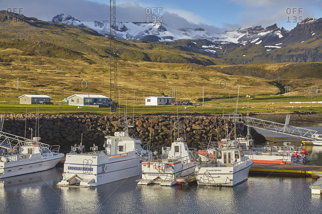 September 23, 2015: Fishing boats in the harbor at Grundarfjordur, with a mountainous backdrop, on the Snaefellsnes peninsula, west Iceland, Polar Regions