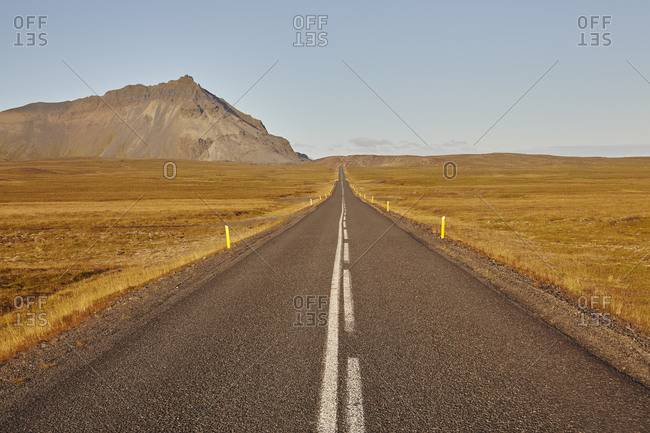 An arrow-straight road cuts across a lava field in Snaefellsjokull National Park, Snaefellsness peninsula, western Iceland, Polar Regions