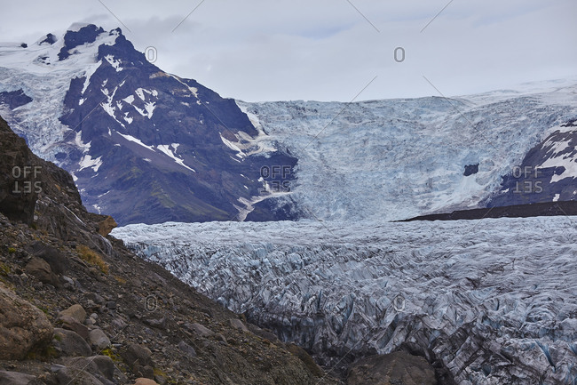 A retreating glacier, pouring down from the Vatnajokull icecap, in Skaftafell National Park, southern Iceland, Polar Regions